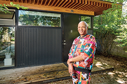 Image of Wallace standing in front of his home