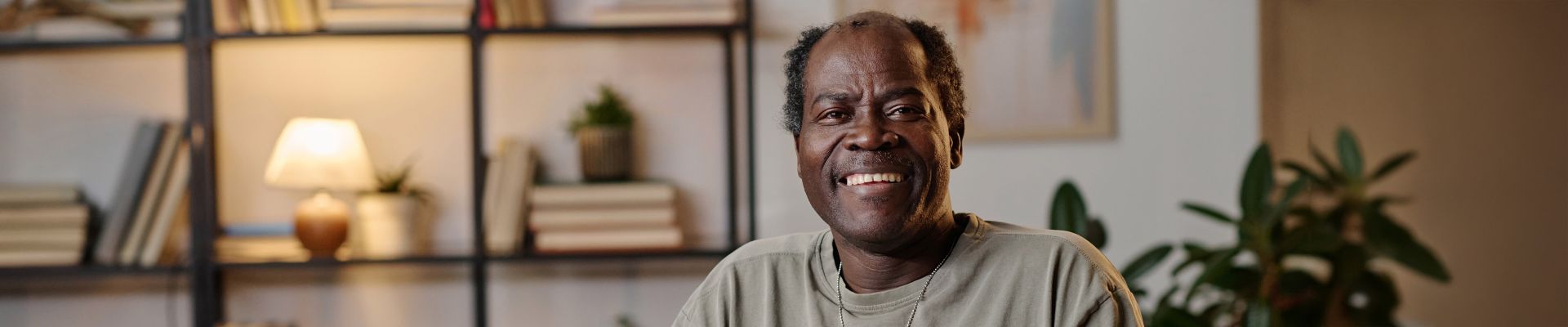 man smiling while sitting in apartment