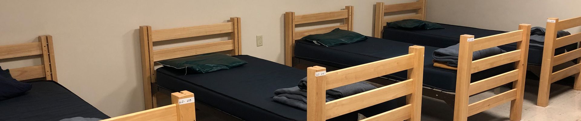 Four beds lined up next to each other
