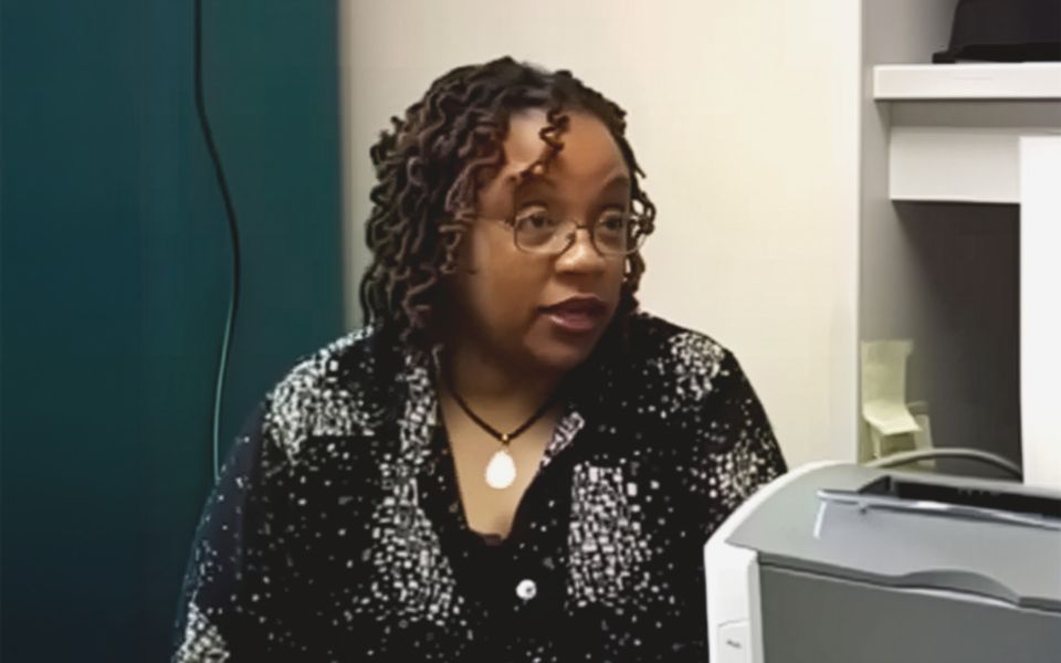 Woman speaking with someone behind the camera
